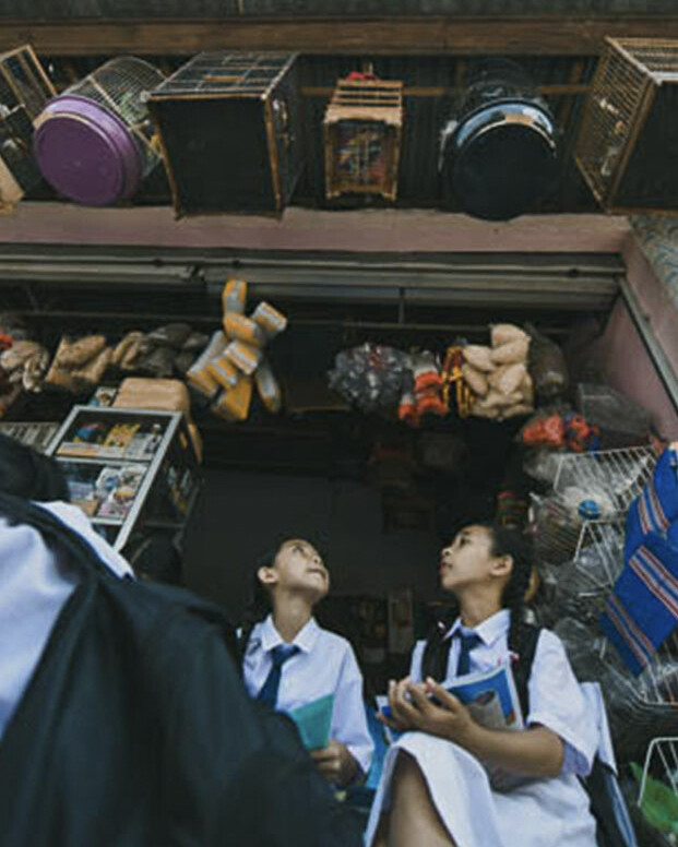 A group of Balinese students participating in a conservation education program, learning about the importance of protecting Bali's biodiversity.