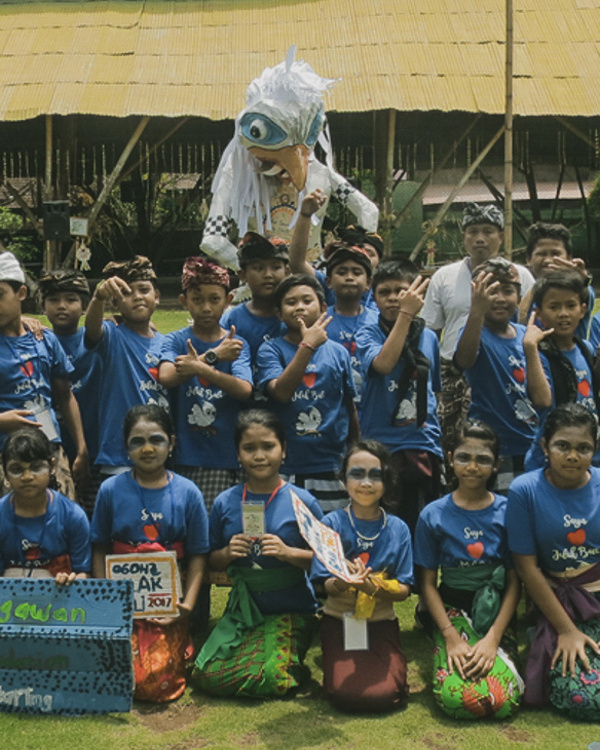 A group of young students participating in the Bali Starling Ambassadors Fun Club, learning about the importance of protecting Bali's biodiversity.