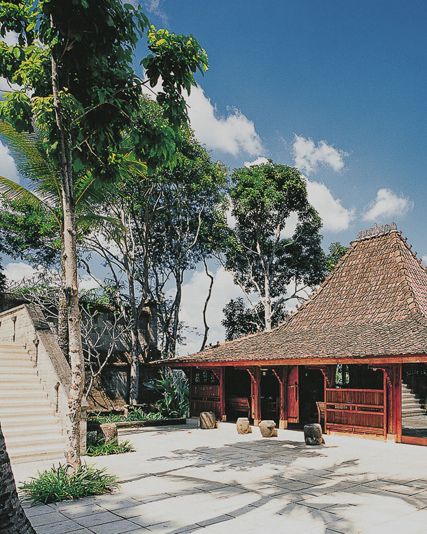 A view of the Kudus House, a finely carved Javanese structure at Begawan Giri Estate, overlooking the Ayung River.